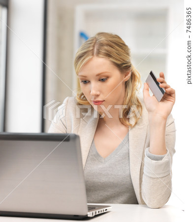 serious woman with laptop computer and credit card serious woman with laptop computer and credit card 7486365