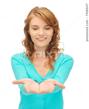 girl showing something on the palms of her hands 7486647