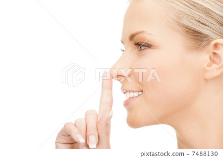 happy woman with finger on lips 7488130