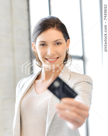 happy woman with credit card 7489692