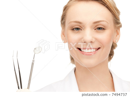 attractive female dentist with tools 7494737