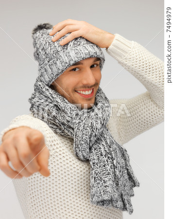 man in winter clothes pointing his finger 7494979