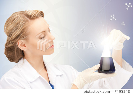 lab worker holding up test tube 7495348