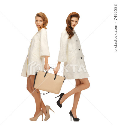 two teenage girls in white coats with bag 7495588