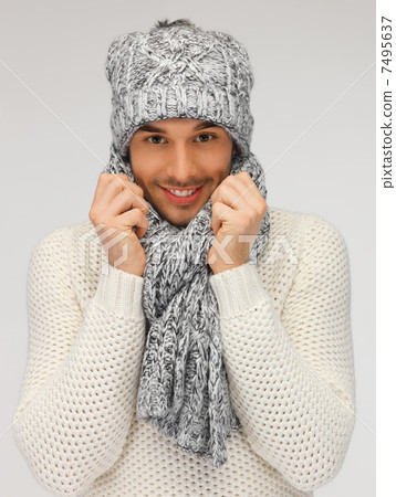 handsome man in warm sweater, hat and scarf 7495637