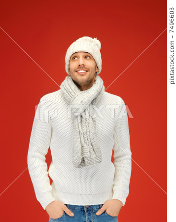 handsome man in warm sweater, hat and scarf 7496603