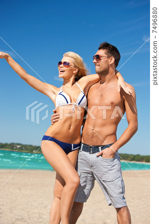 happy couple in sunglasses on the beach happy couple in sunglasses on the beach 7496880