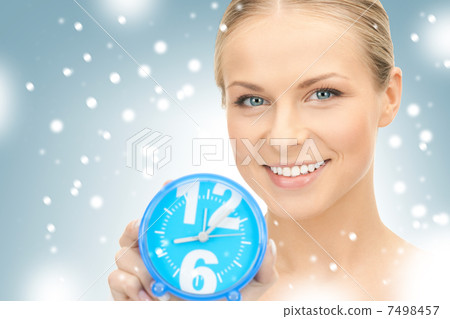 woman holding alarm clock 7498457