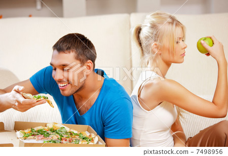 couple eating different food couple eating different food 7498956
