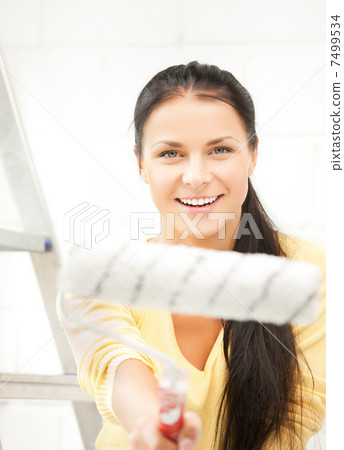 happy young woman with paintroller happy young woman with paintroller 7499534