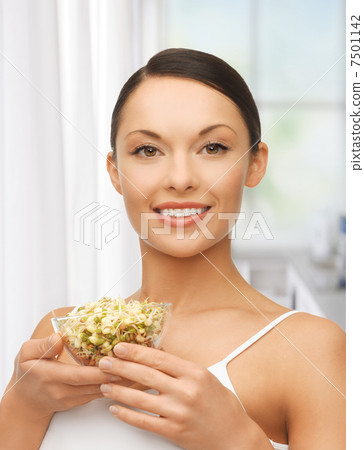 healthy woman holding bowl with sprout 7501142