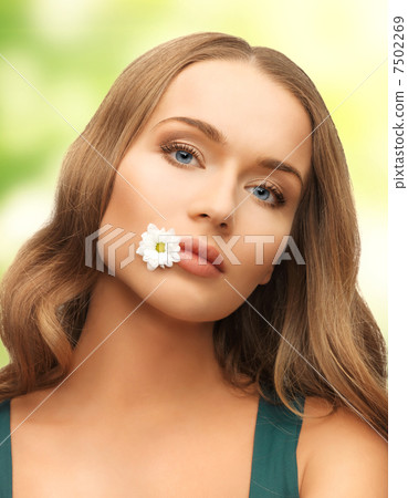 woman with camomile in mouth 7502269