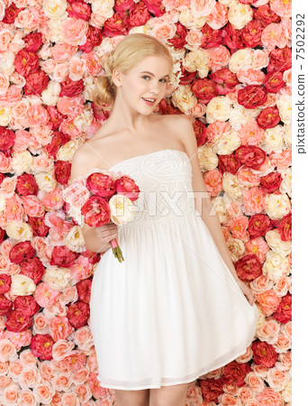 woman with bouquet and background full of roses woman with bouquet and background full of roses 7502292