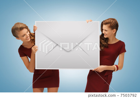 girls holding big envelope girls holding big envelope 7503792