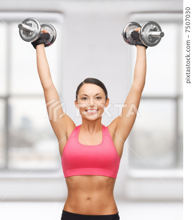 woman with heavy steel dumbbells woman with heavy steel dumbbells 7507030