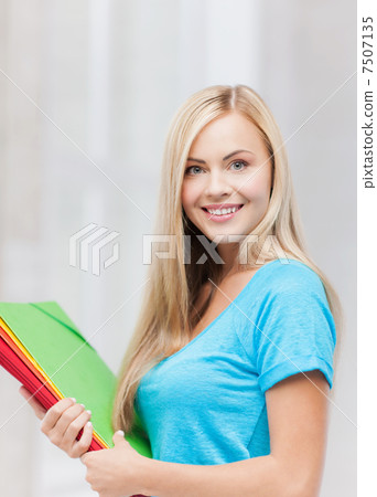 smiling student with folders smiling student with folders 7507135