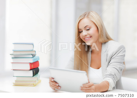 student with books and tablet pc 7507310