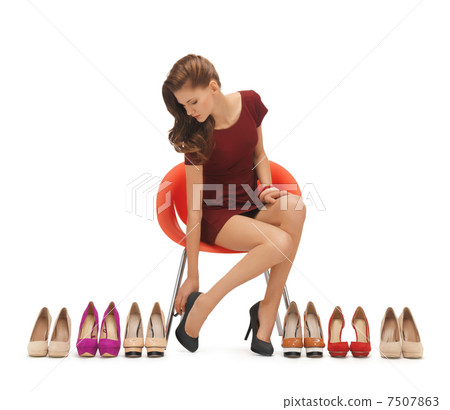 woman trying on high heeled shoes 7507863