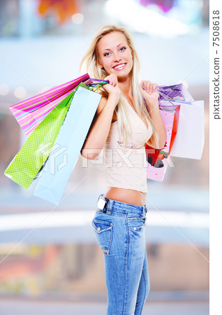 woman with shopping bags at shop 7508618