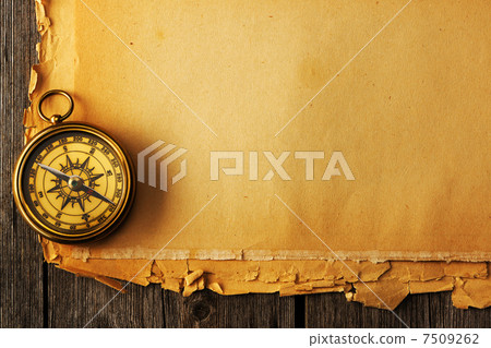 Antique brass compass over old background Antique brass compass over old background 7509262