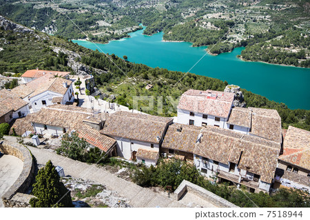 Guadalest lake and village. Reservoir and tiling roofs. 7518944