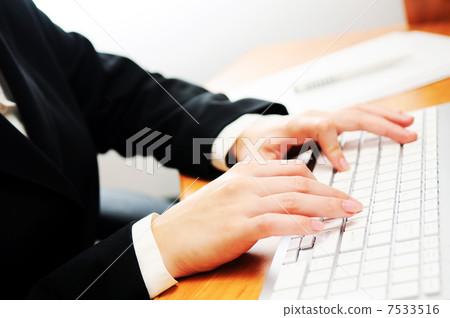 Female hands typing on a keyboard Female hands typing on a keyboard 7533516