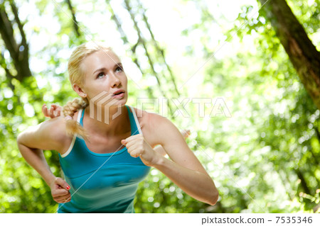 Woman Running Outdoors in Forest Woman Running Outdoors in Forest 7535346