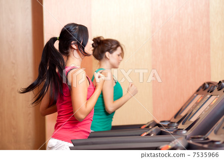 Young women on a running simulator Young women on a running simulator 7535966