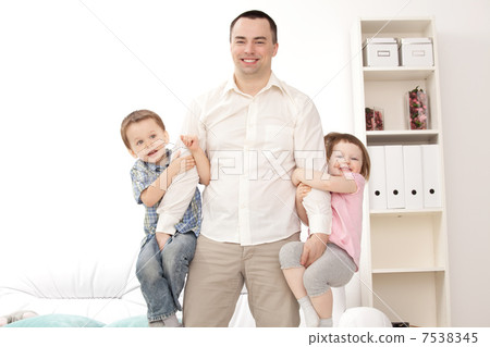 Portrait of a happy young guy with kids Portrait of a happy young guy with kids 7538345