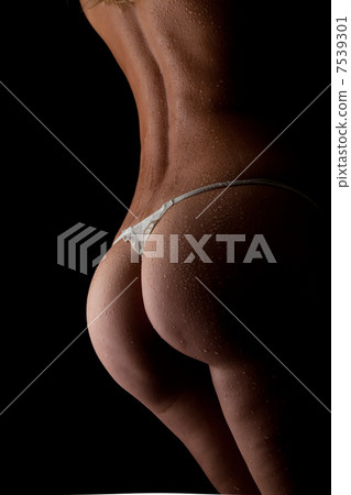 Beautiful ass of young woman over dark background Beautiful ass of young woman over dark background 7539301