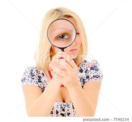 Girls eye magnified through magnified glass Girls eye magnified through magnified glass 7540234