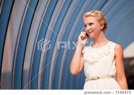 Beautiful woman talking over a phone Beautiful woman talking over a phone 7540473
