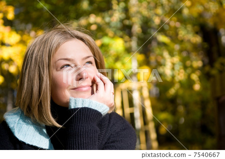 Closeup of beautiful woman thinking over autumn background 7540667