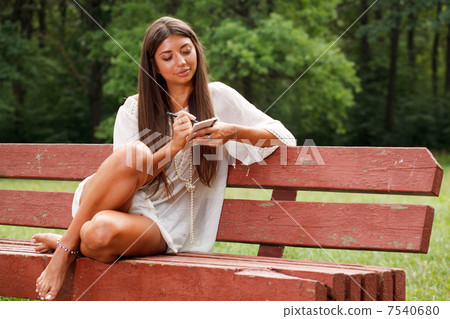 Beautiful woman reading small book 7540680