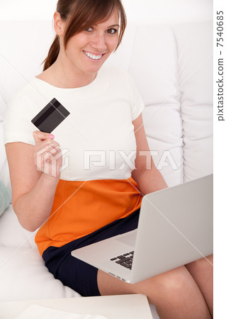 Closeup portrait of woman with a laptop and card Closeup portrait of woman with a laptop and card 7540685