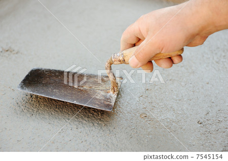 Construction worker spreading wet concrete Construction worker spreading wet concrete 7545154