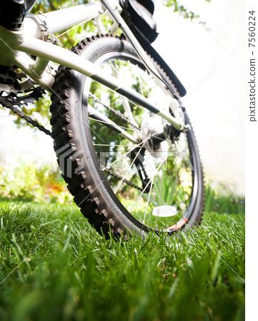 Bicycle in the grass, close up photo Bicycle in the grass, close up photo 7560224