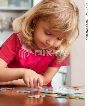 Girl, playing puzzles 7567249