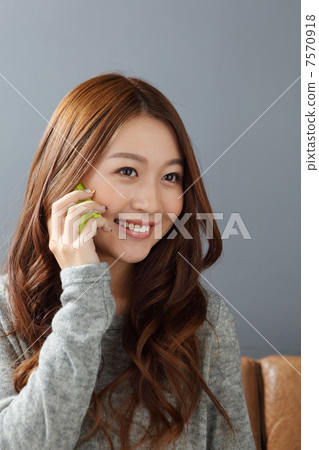 A woman using a mobile phone 7570918