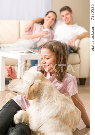 Playful girl petting family dog with parents Playful girl petting family dog with parents 7580526