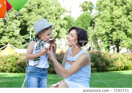 Happy mother and little son with ice-creams outdoors Happy mother and little son with ice-creams outdoors 7583731