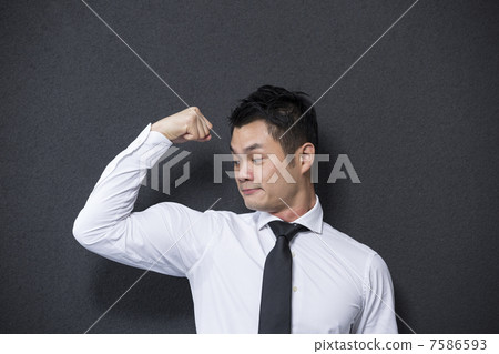 Chinese business man flexing his large bicep. 7586593