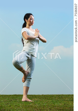 Chinese woman meditating and in yoga pose 7586607
