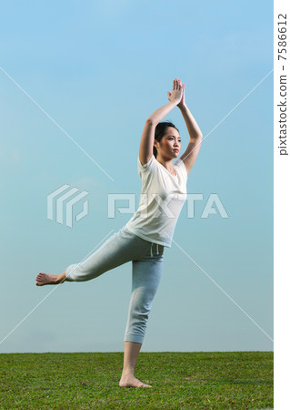 Chinese woman meditating and in yoga pose 7586612
