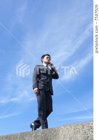 Businessmen talking on mobile phones Businessmen talking on mobile phones 7587026