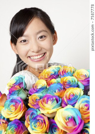 A woman with a bouquet of rainbow roses A woman with a bouquet of rainbow roses 7587778