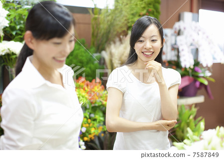 A woman with a clerk of a florist and a customer A woman with a clerk of a florist and a customer 7587849