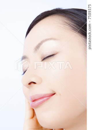 A woman holding a cheek A woman holding a cheek 7589375