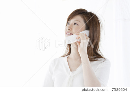 A woman who makes a phone call by cell phone A woman who makes a phone call by cell phone 7589604