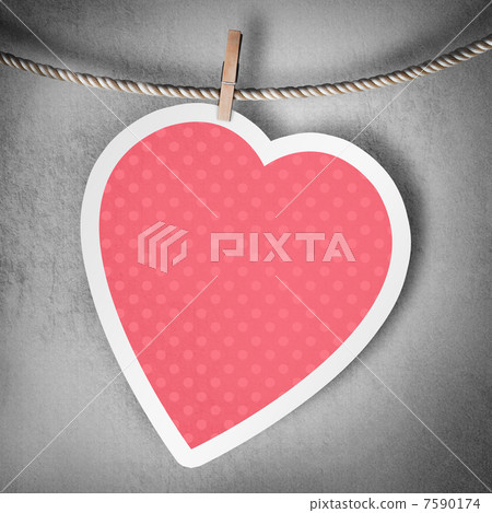 Paper heart hanging on a rope on grunge background 7590174